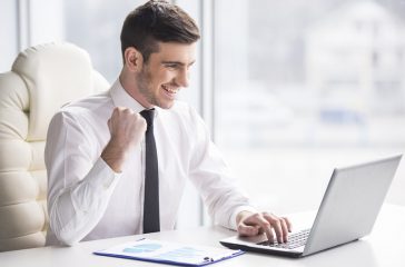 Businessman happy with laptop