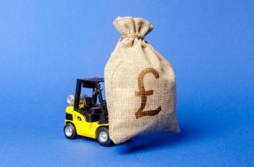 Yellow forklift truck carries a bag of pound sterling. Attracting investment in development, modernization of production and business. Revenue, profit, liquidity. profit fixation. capital migration