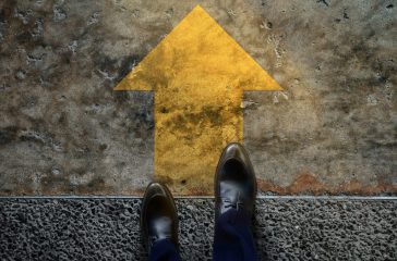Start and Challenge Concept. a Business Man on Formal Shoes Steps to Follow a Yellow Arrow, Get Ready to Moving Forward or take a Chance to Success. Top View