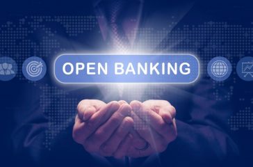 Businessmans cupped hands holding an Open Banking business concept on a computerised display.