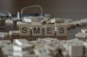 the acronym smes for Small and Medium-sized Enterprises concept represented by wooden letter tiles