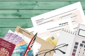 English Tax form sa105 UK Property from HM revenue and customs lies on table with office items. HMRC paperwork and tax paying process in United Kingdom