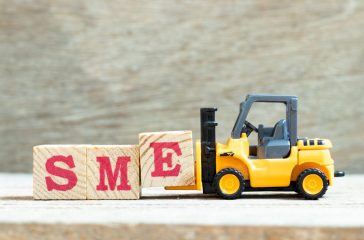 Toy forklift hold letter block e to complete word SME (abbreviat
