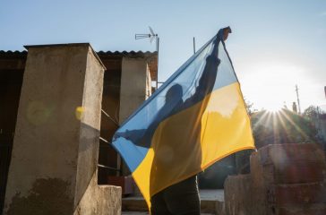 Unrecognizable person holds up his Ukrainian flag to claim no to
